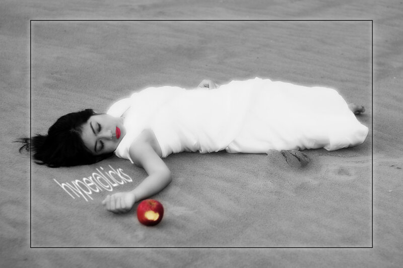 woman sleeping on sand with apple