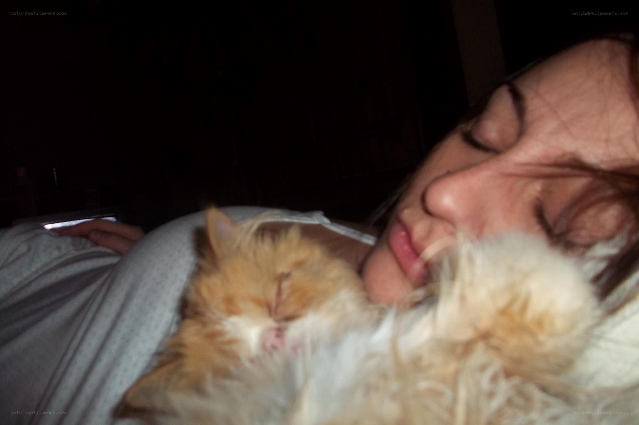 woman sleeping with cat