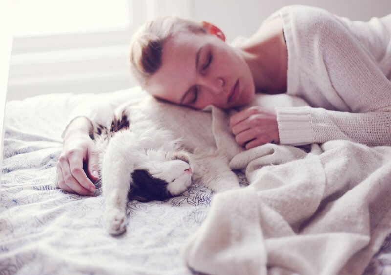 woman sleeping with cat