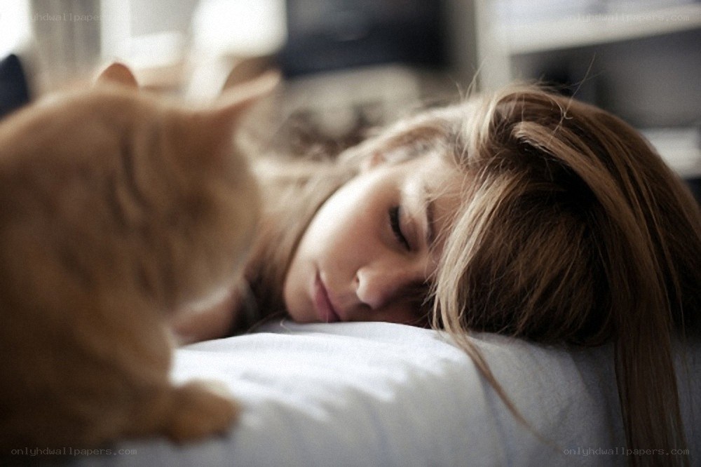 woman sleeping with cat