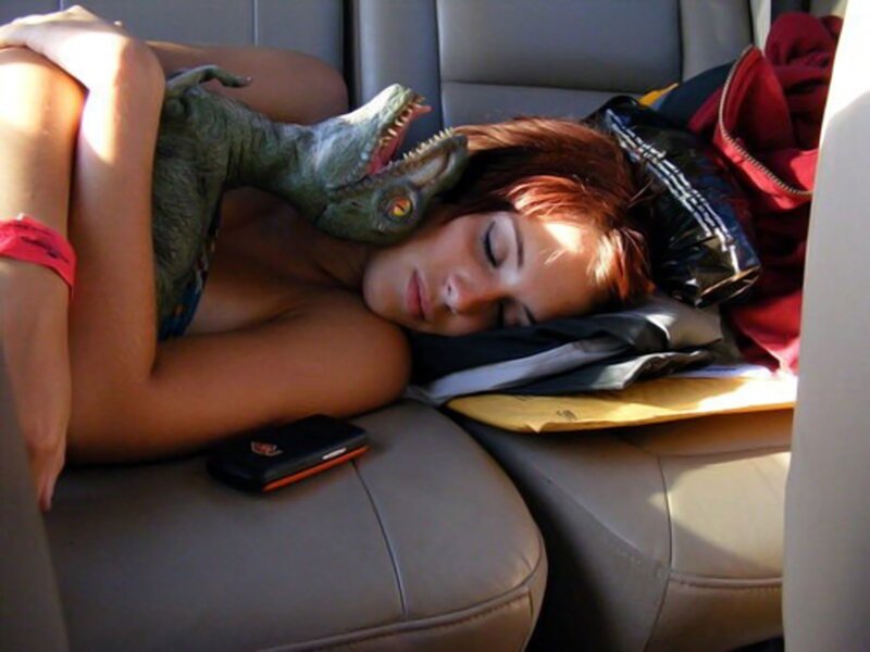 Woman sleeping with dinosaur toy