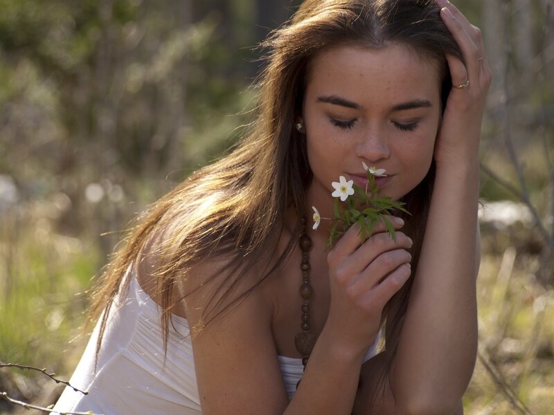 woman smelling a flower