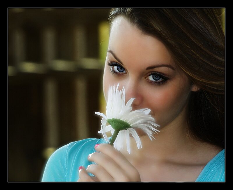 woman smelling a white flower