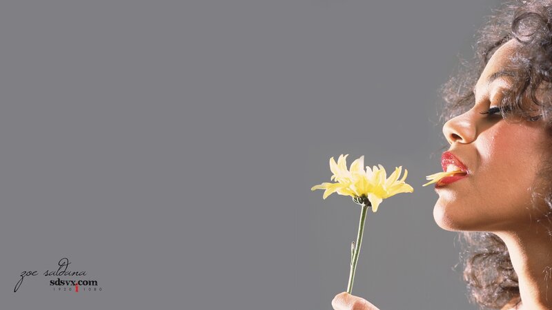 woman smelling a yellow flower
