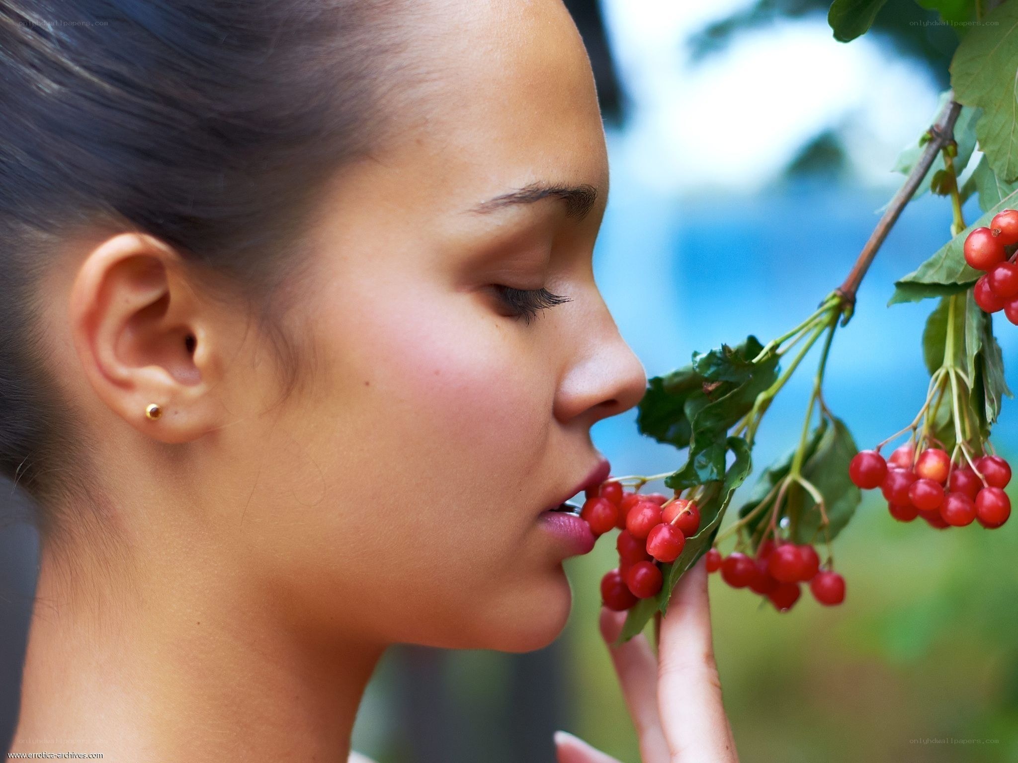 woman smelling berries