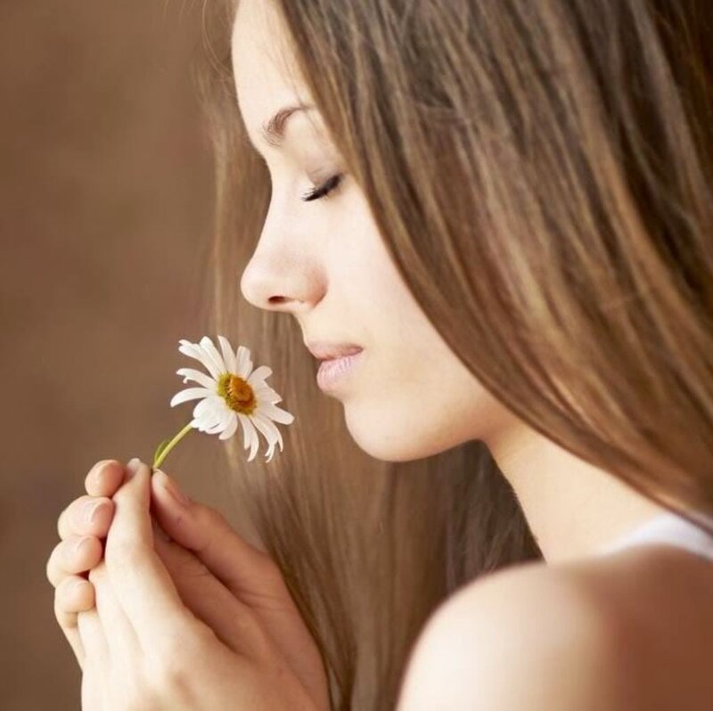 Woman Smelling Daisy