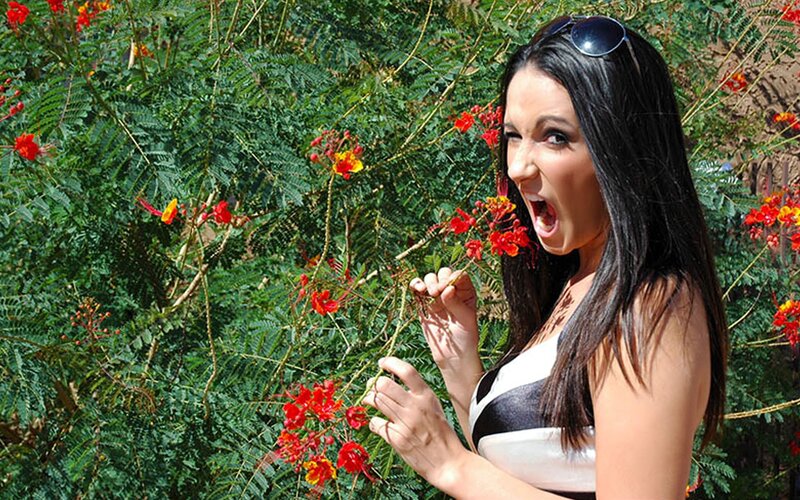 Woman smelling flowers outdoors