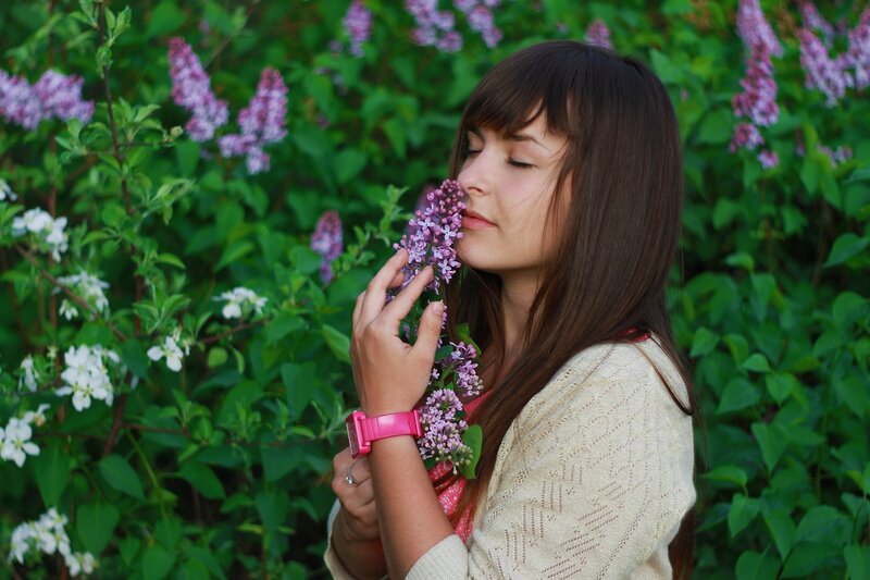 woman smelling lilac flowers