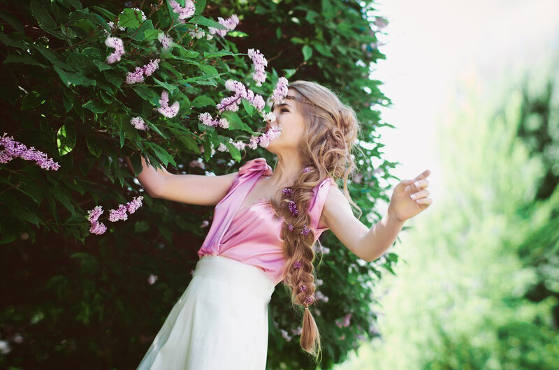 Woman Smelling Lilacs
