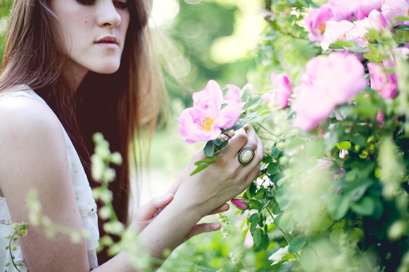 woman smelling pink flowers