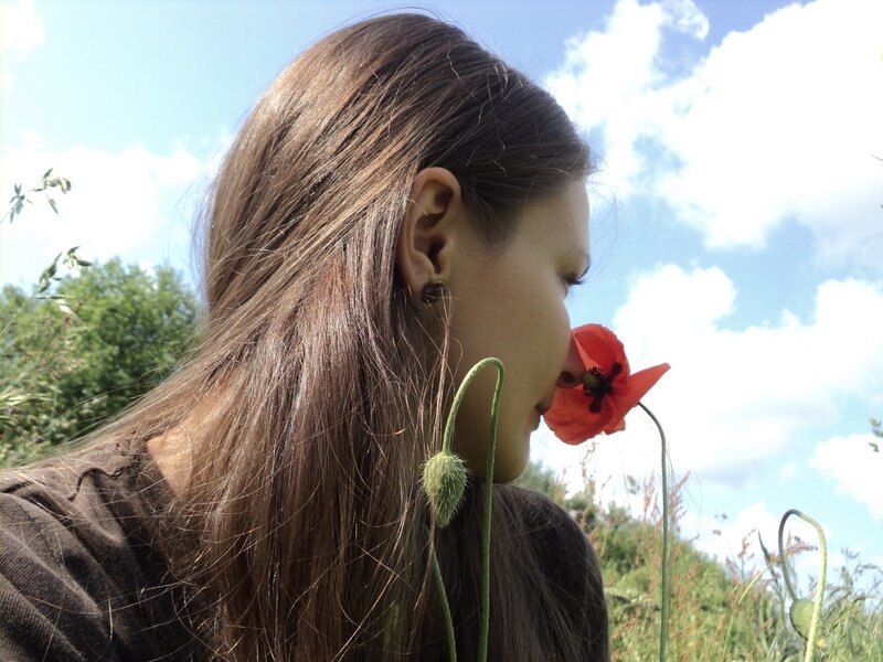 Woman Smelling Poppy