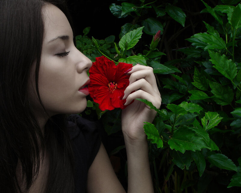 Woman Smelling Red Flower — Serene