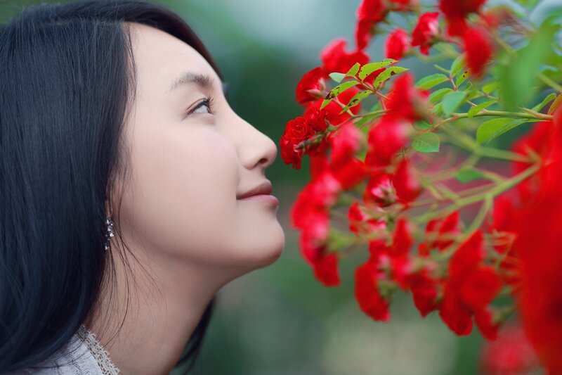 Woman Smelling Red Roses — Serene