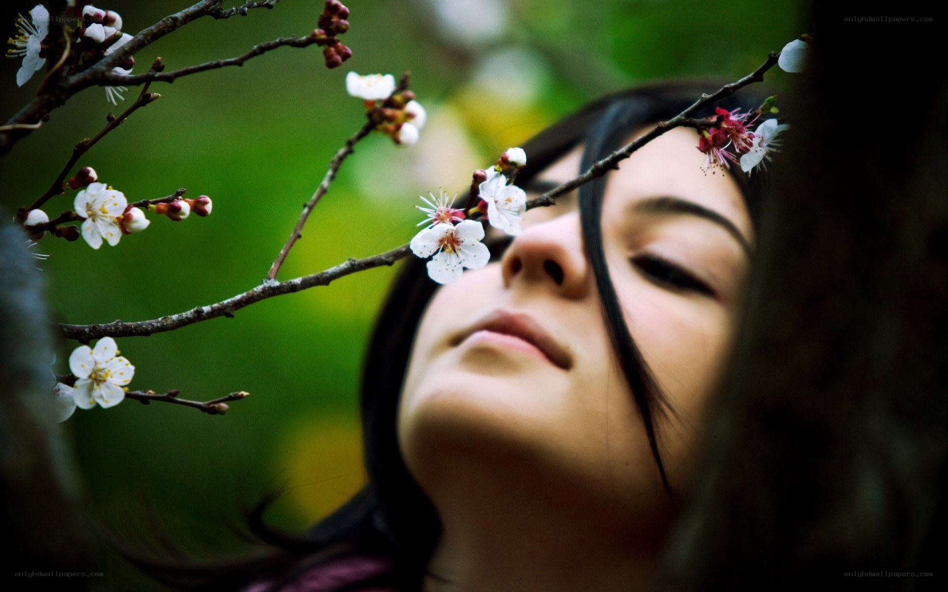 woman smelling spring blossoms