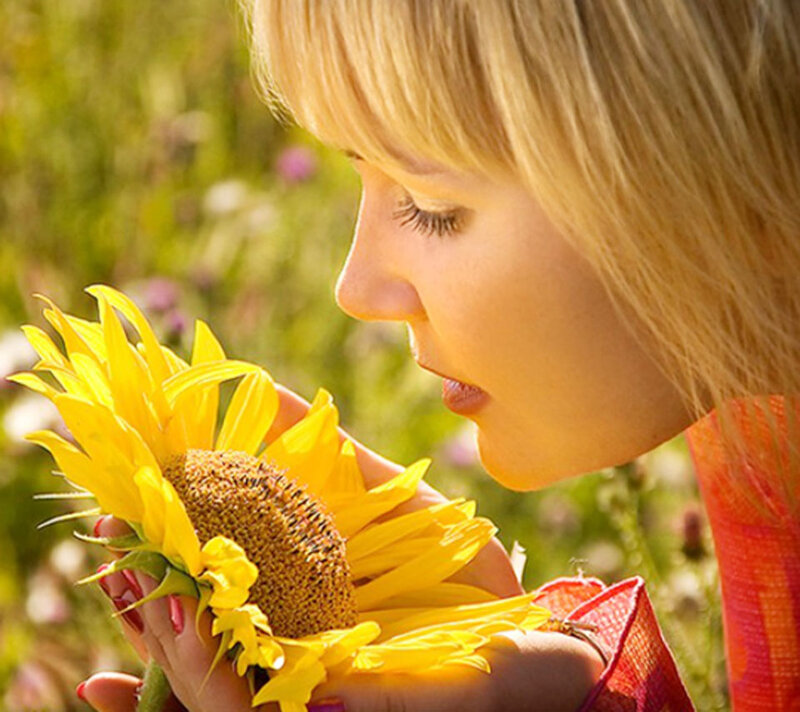 Woman Smelling Sunflower — Yellow