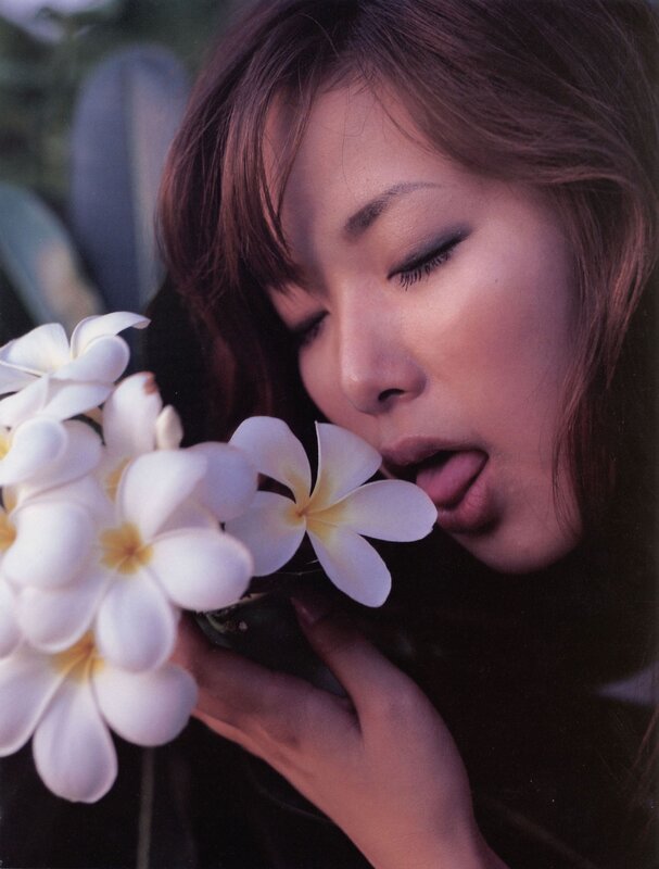 woman smelling white flowers
