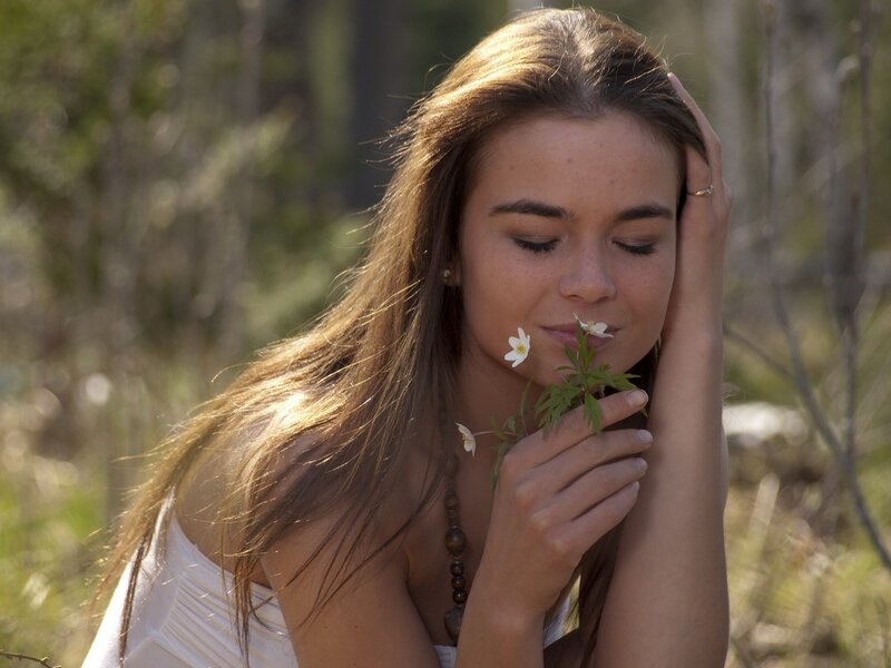 woman smelling wildflowers
