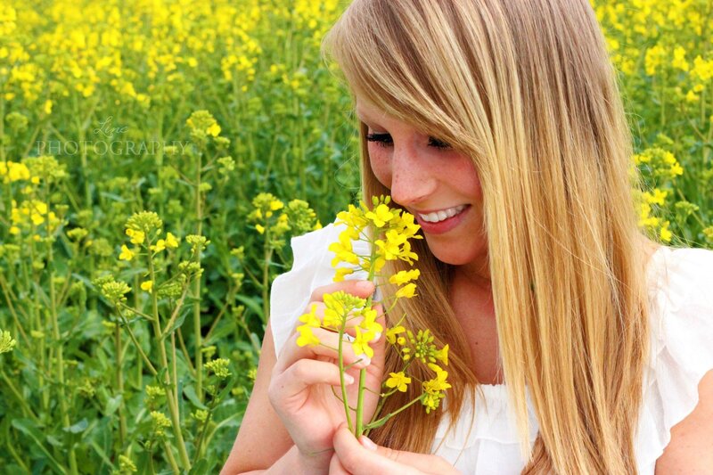Woman smelling yellow flowers