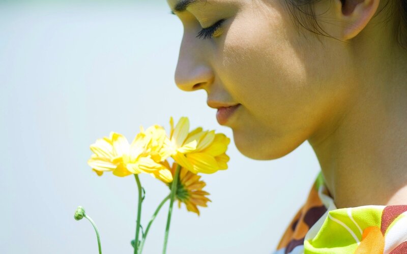 Woman Smelling Yellow Flowers — Serene