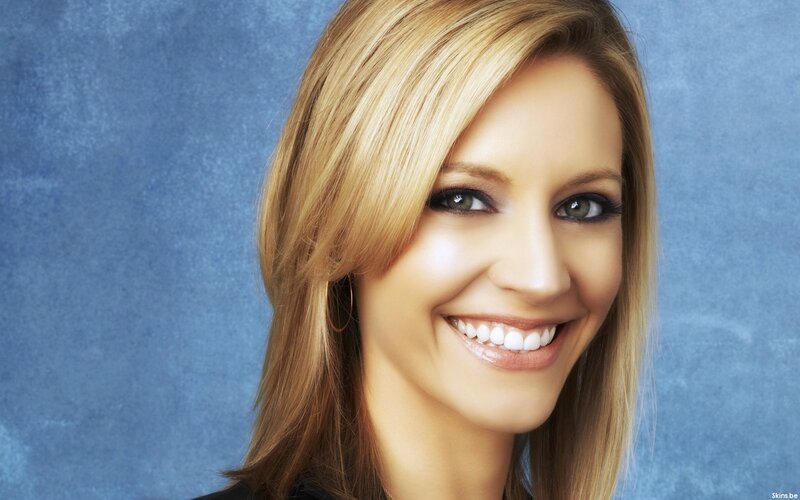 woman smiling against blue background