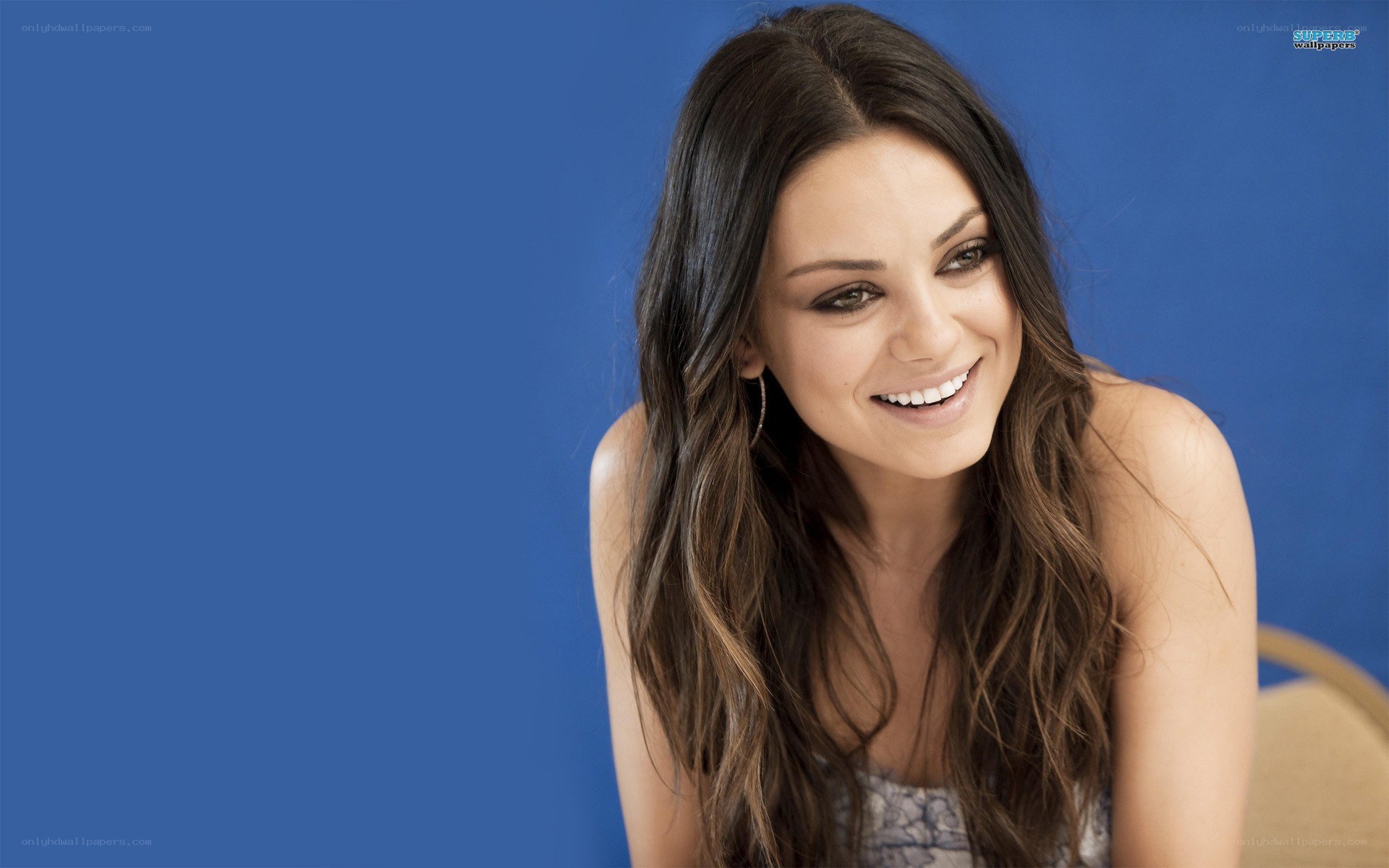 woman smiling against blue background