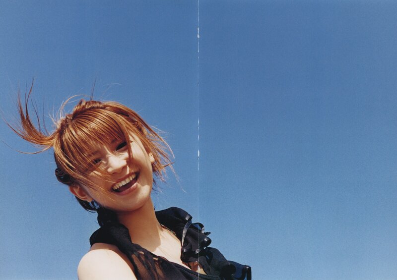 woman smiling against blue sky