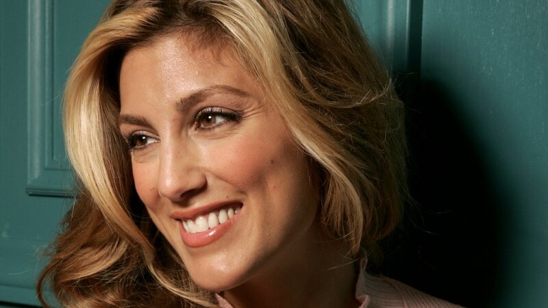 woman smiling against green wall