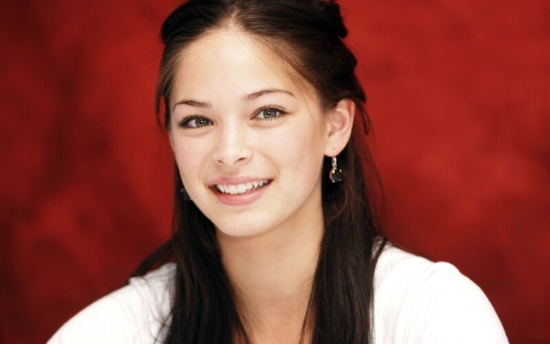 woman smiling against red background