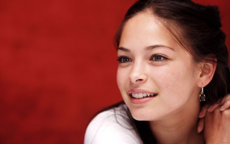 woman smiling against red background