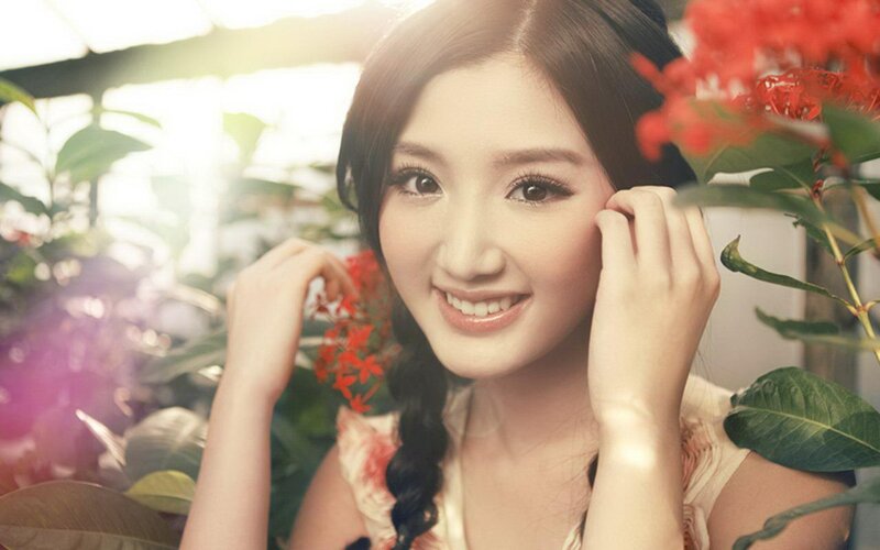 woman smiling among flowers