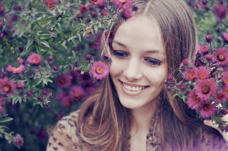 woman smiling among purple flowers