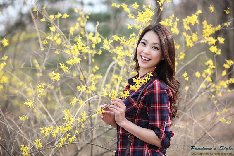 Woman smiling among yellow flowers