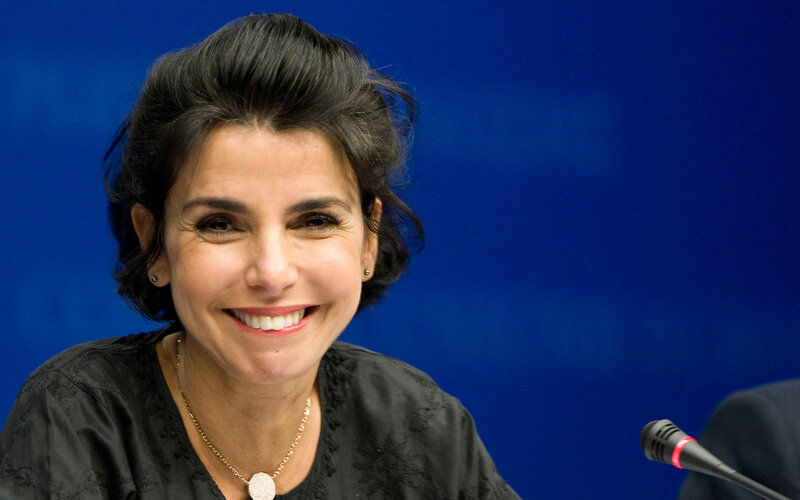 woman smiling at a press event