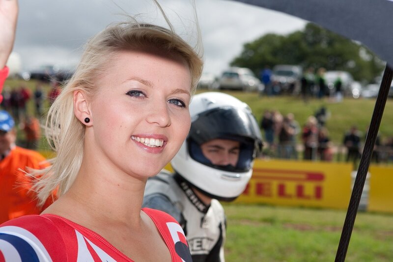 Woman smiling at a race track