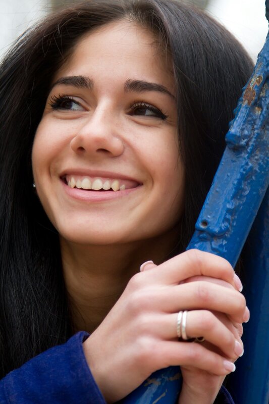 woman smiling at blue pole