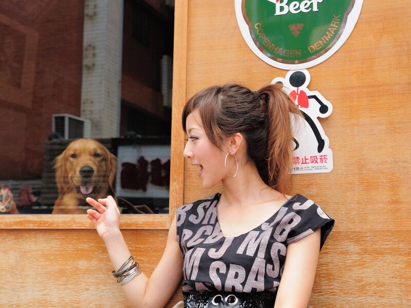Woman smiling at dog in window