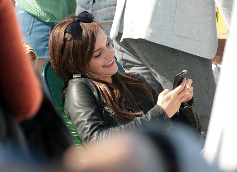 woman smiling at phone
