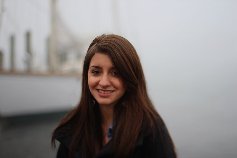 woman smiling at the harbor