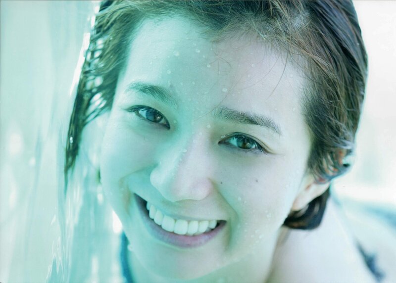 woman smiling behind glass