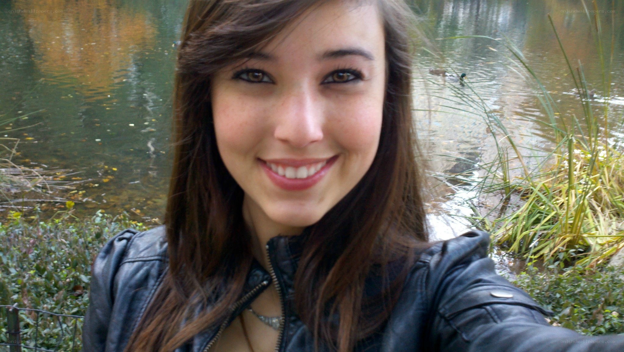 woman smiling by a pond