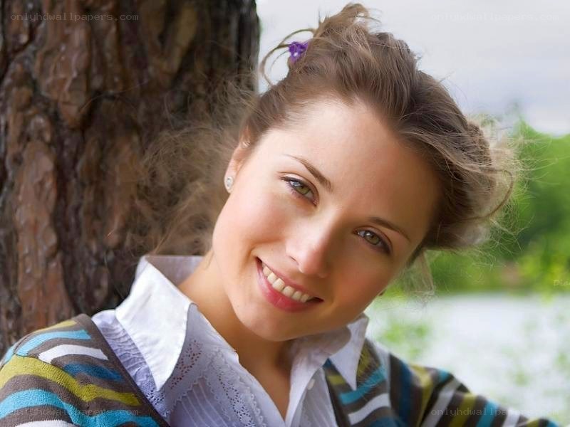 woman smiling by a tree