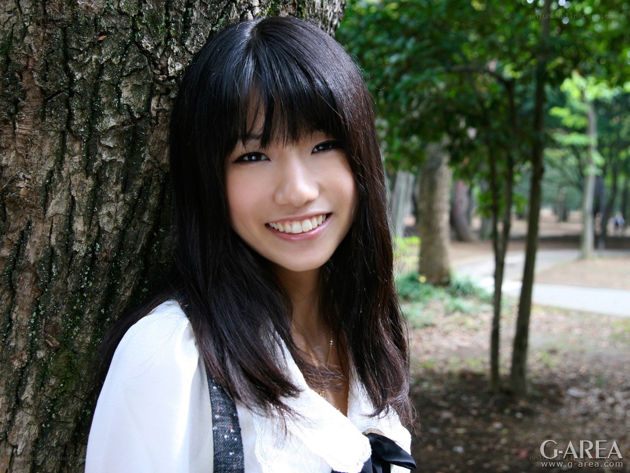 woman smiling by a tree