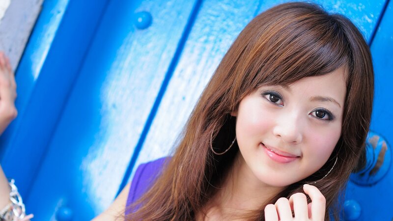 woman smiling by blue wall