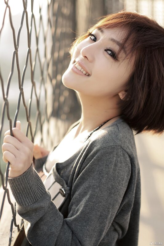 woman smiling by fence