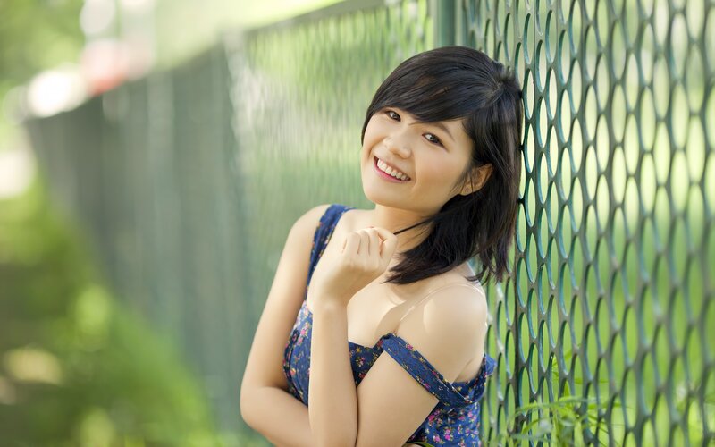 woman smiling by fence