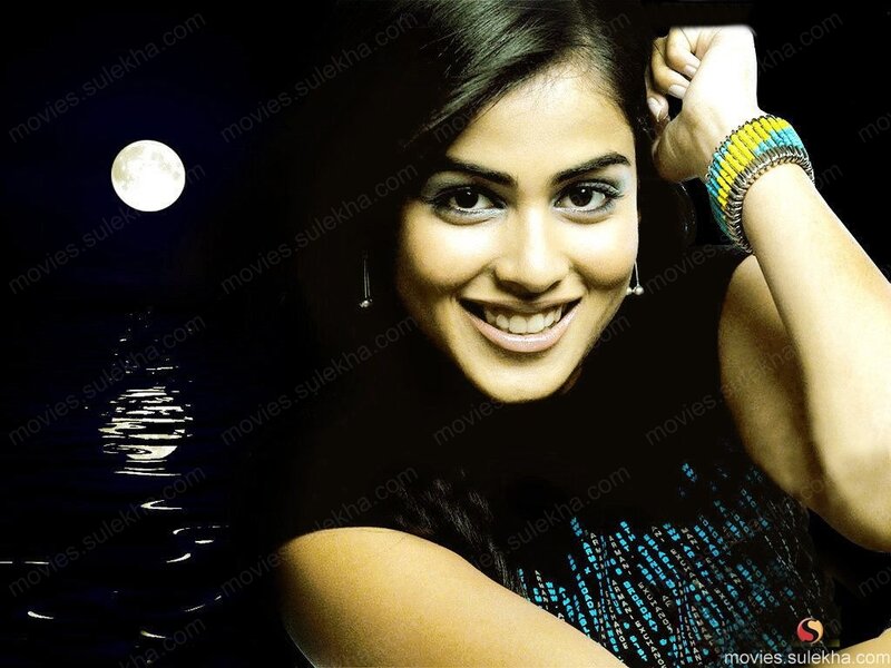 woman smiling by moonlit water