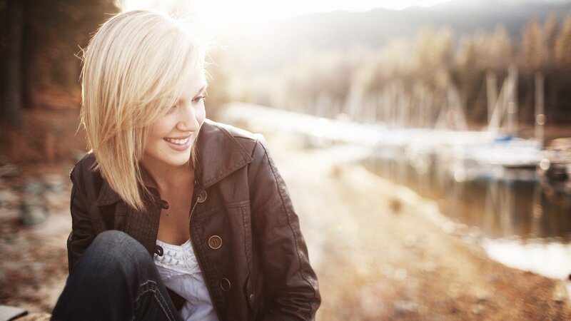 woman smiling by the lake