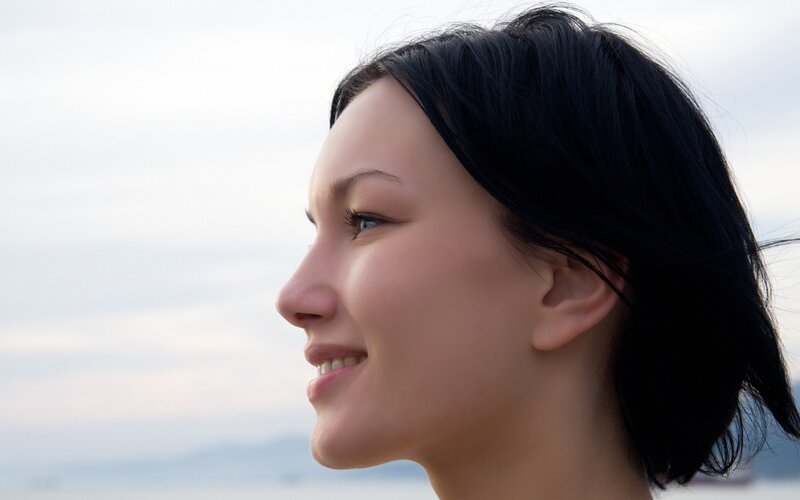woman smiling by the water