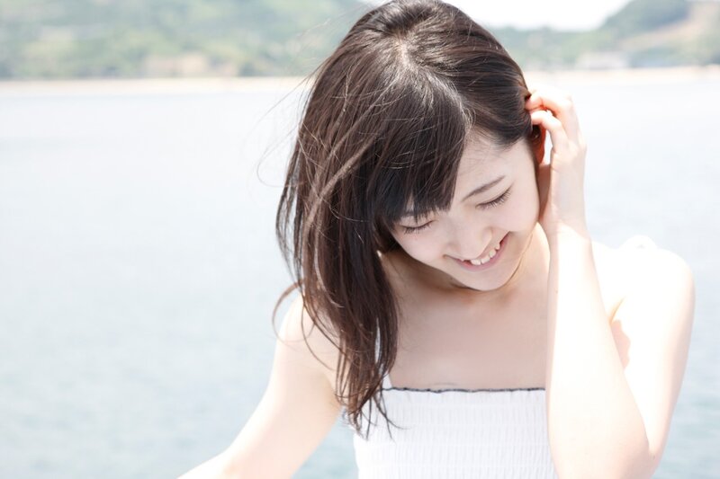 woman smiling by the water