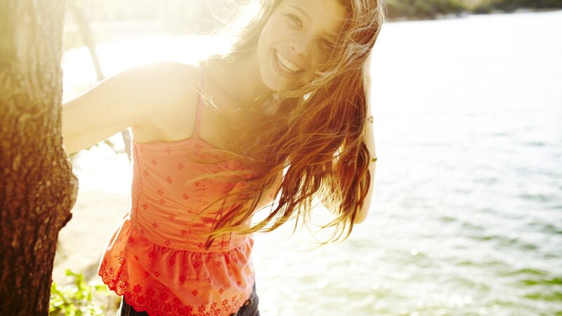 woman smiling by the water